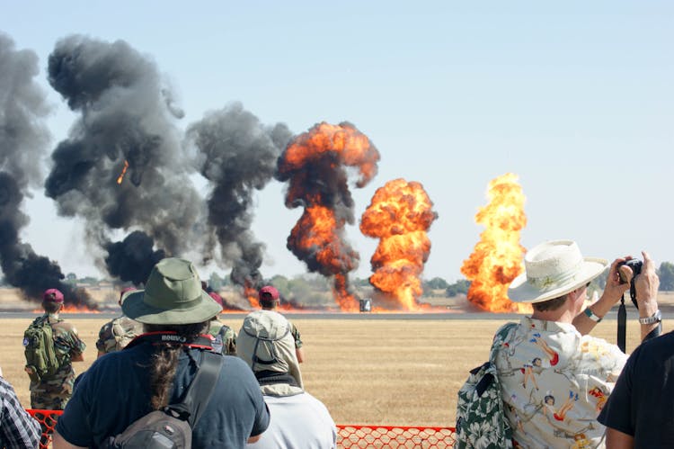 People Watching Show With Fire On Tarmac