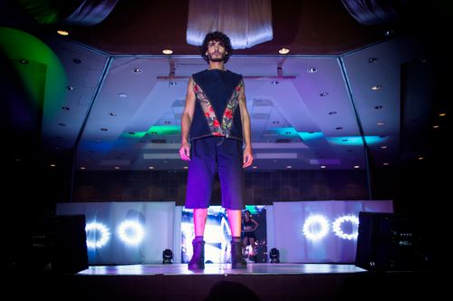 Free Male model on a vibrant fashion runway at an indoor venue in Morelia, Mexico. Stock Photo