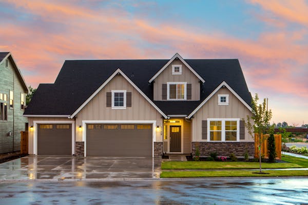 New construction craftsman style home at dusk