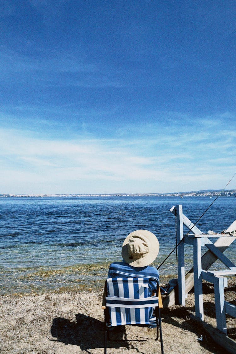 Person Fishing On The Seashore