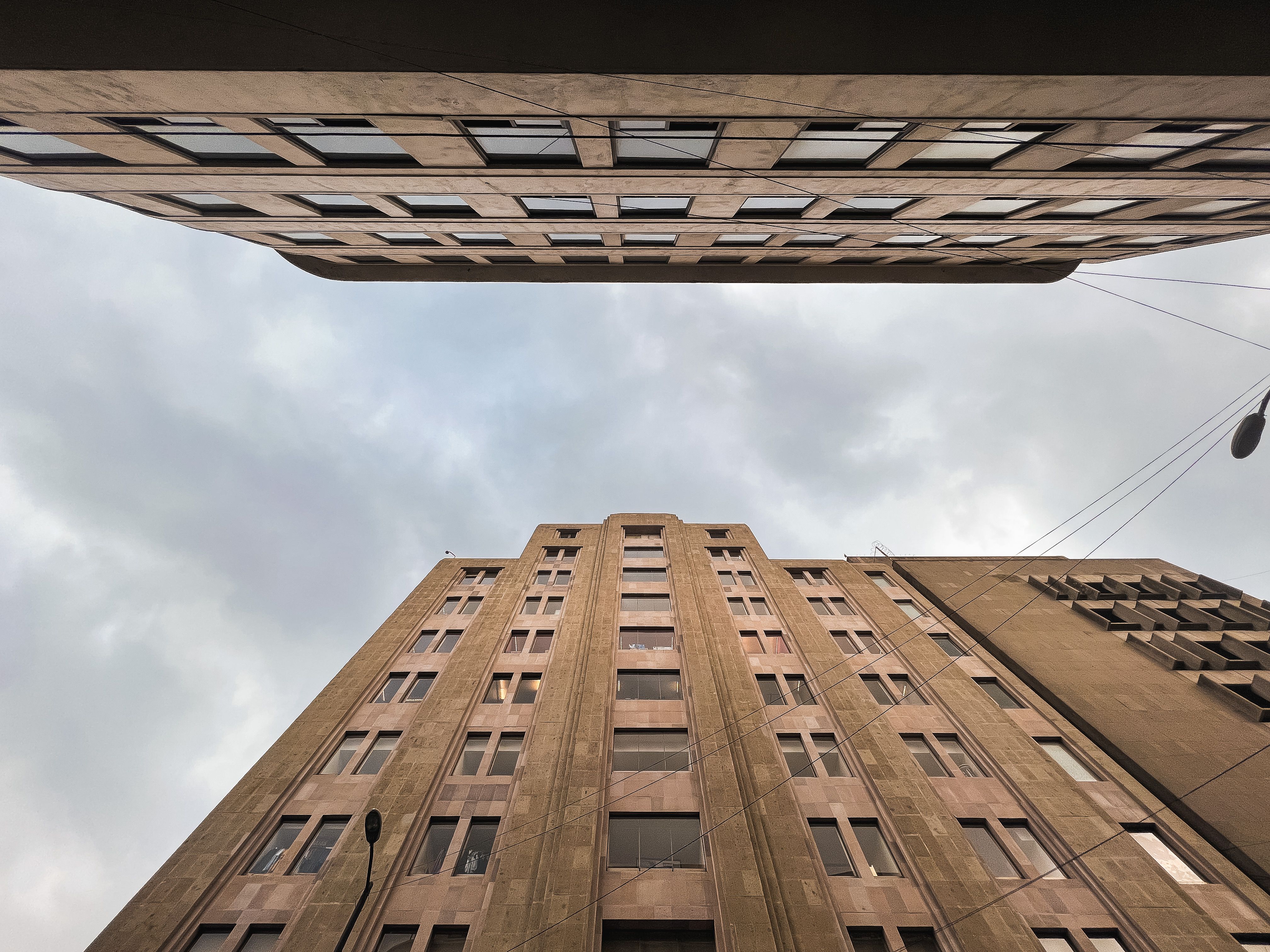 Low-Angle Shot of Concrete Buildings under the Blue Sky · Free Stock Photo