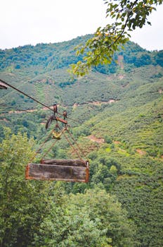 Traditional cable car rides over lush green hills of Espiye, Giresun, Turkey. Experience rural landscapes.