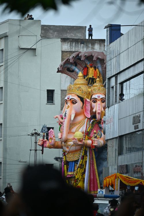 Free A large and vibrant Ganesha statue part of a city festival parade, highlighting cultural significance. Stock Photo