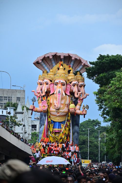 Free Large Ganesh statue parade in city, showcasing vibrant cultural festival with crowds. Stock Photo