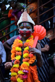 Colorfully costumed child in a traditional Indian festival parade celebrating culture and heritage.
