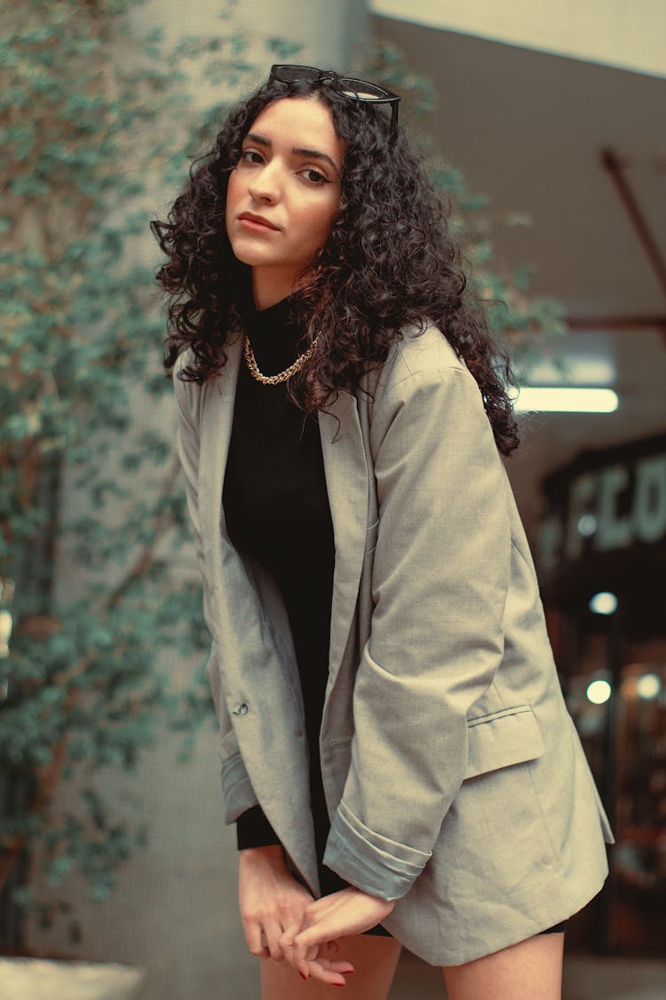 A Woman In Black Turtleneck Top And Gray Blazer 