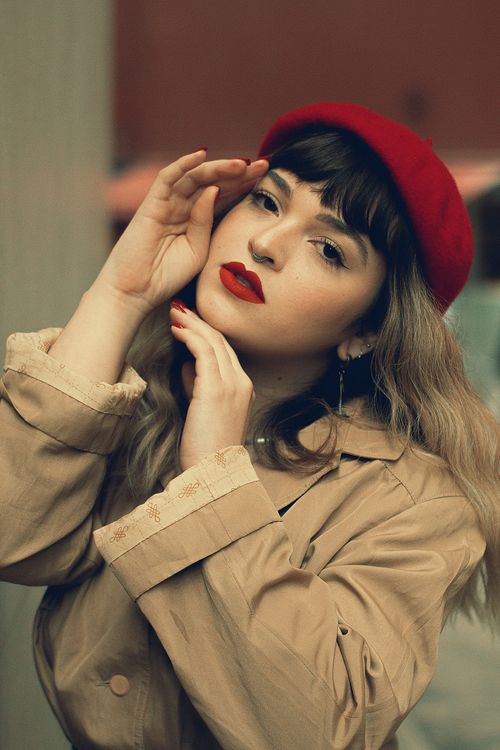 Free Portrait of a fashionable woman in São Paulo wearing a red beret and trench coat. Stock Photo