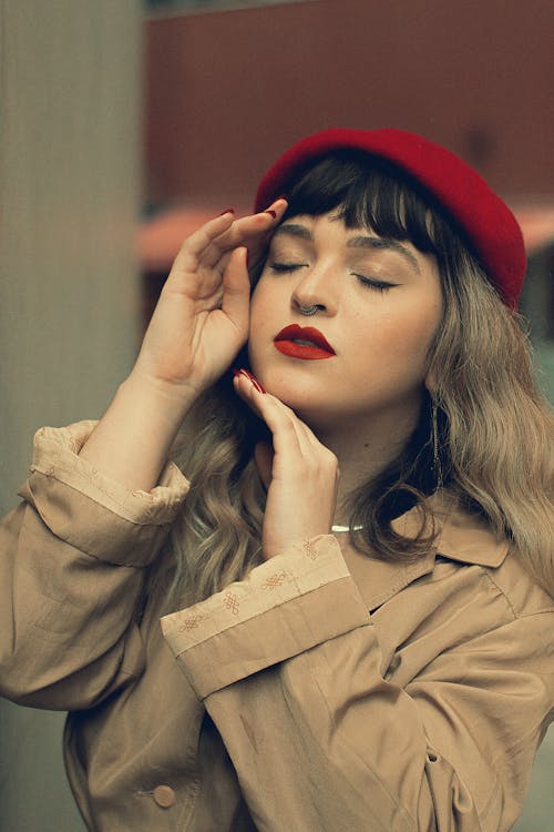 Young Woman in a Trench Coat and Red Beret 