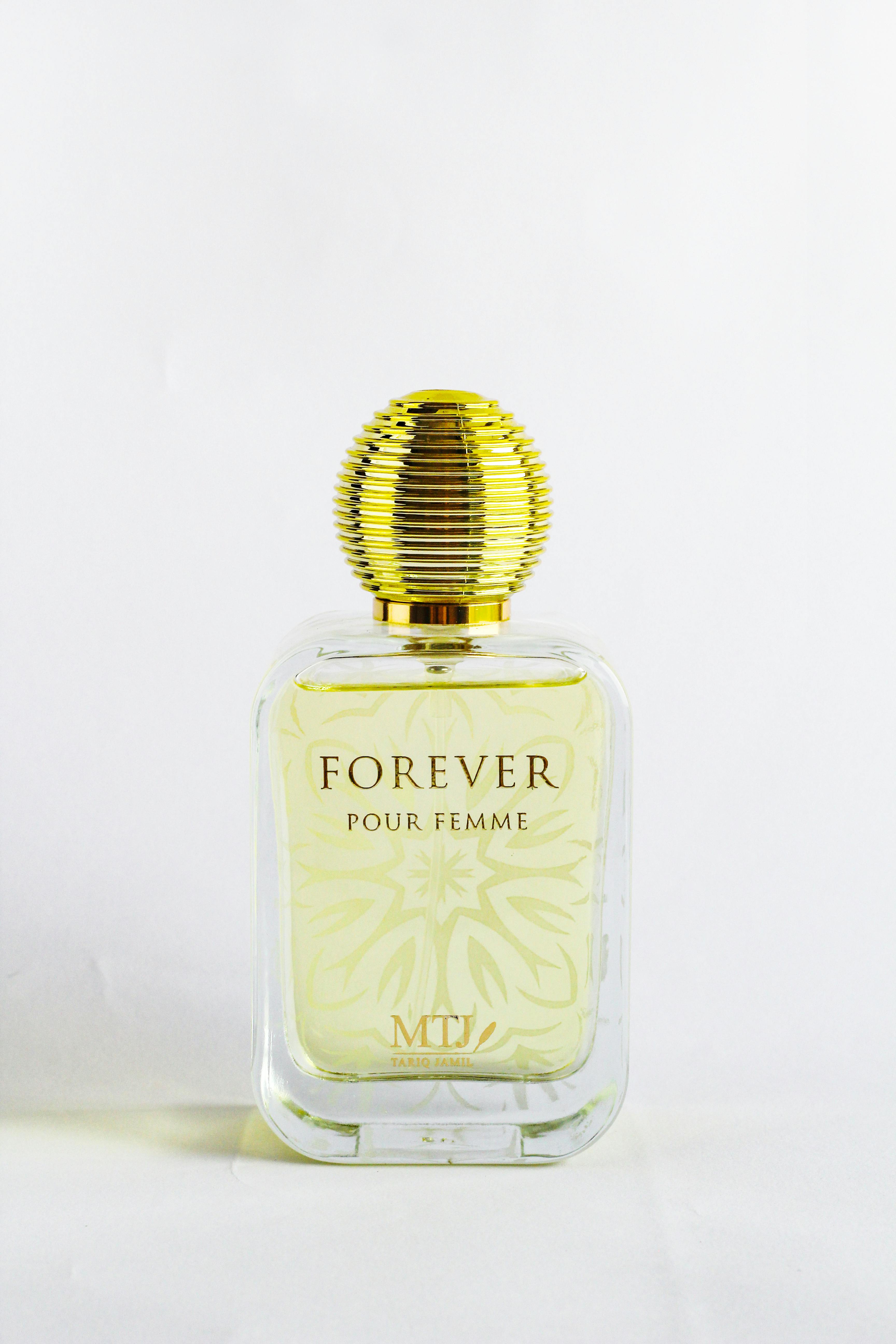 Square Glass Perfume Bottle on White Sand · Free Stock Photo