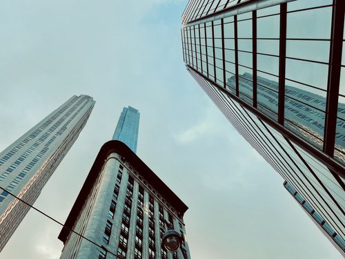Free Low-angle shot of New York City skyscrapers reflecting the clear sky, showcasing urban architecture. Stock Photo