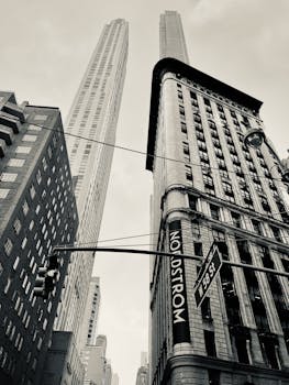 Black and white cityscape of skyscrapers from a low angle in New York City.