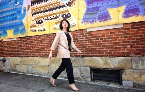 Woman Standing on Sidewalk