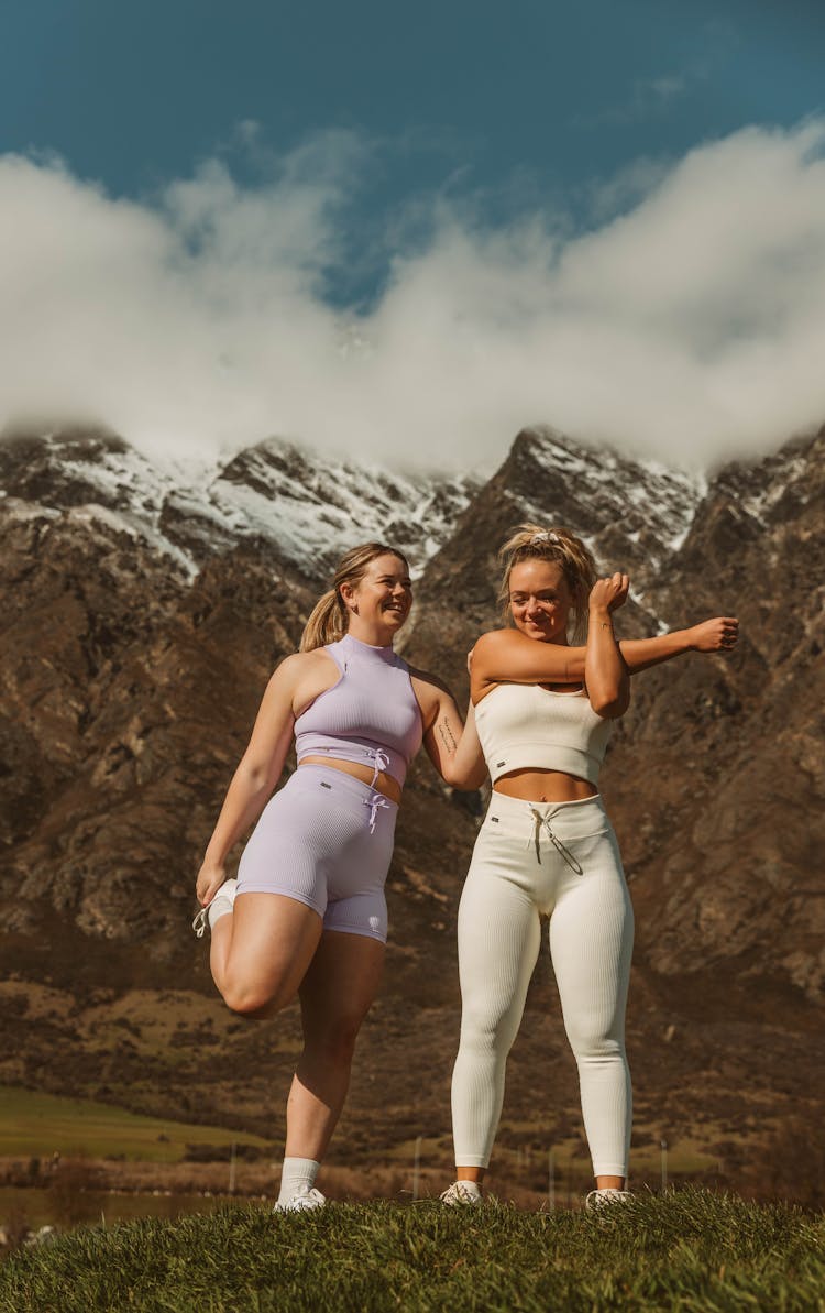 Women Stretching In Mountains