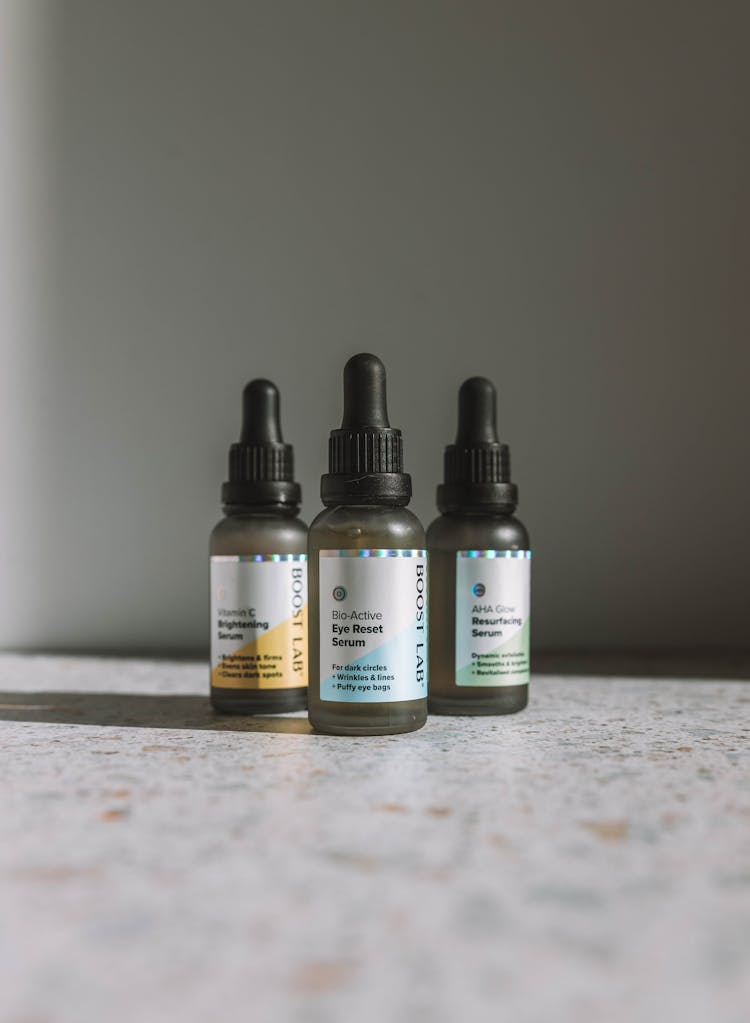 Bottles With Cosmetic Product On Table In Studio