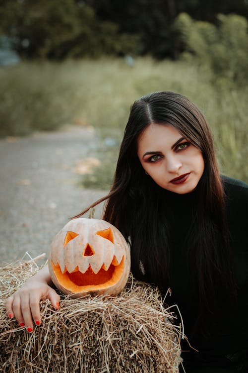 Woman Posing with Halloween Pumpkin