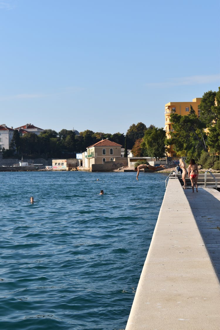 People Jumping To Water In Town