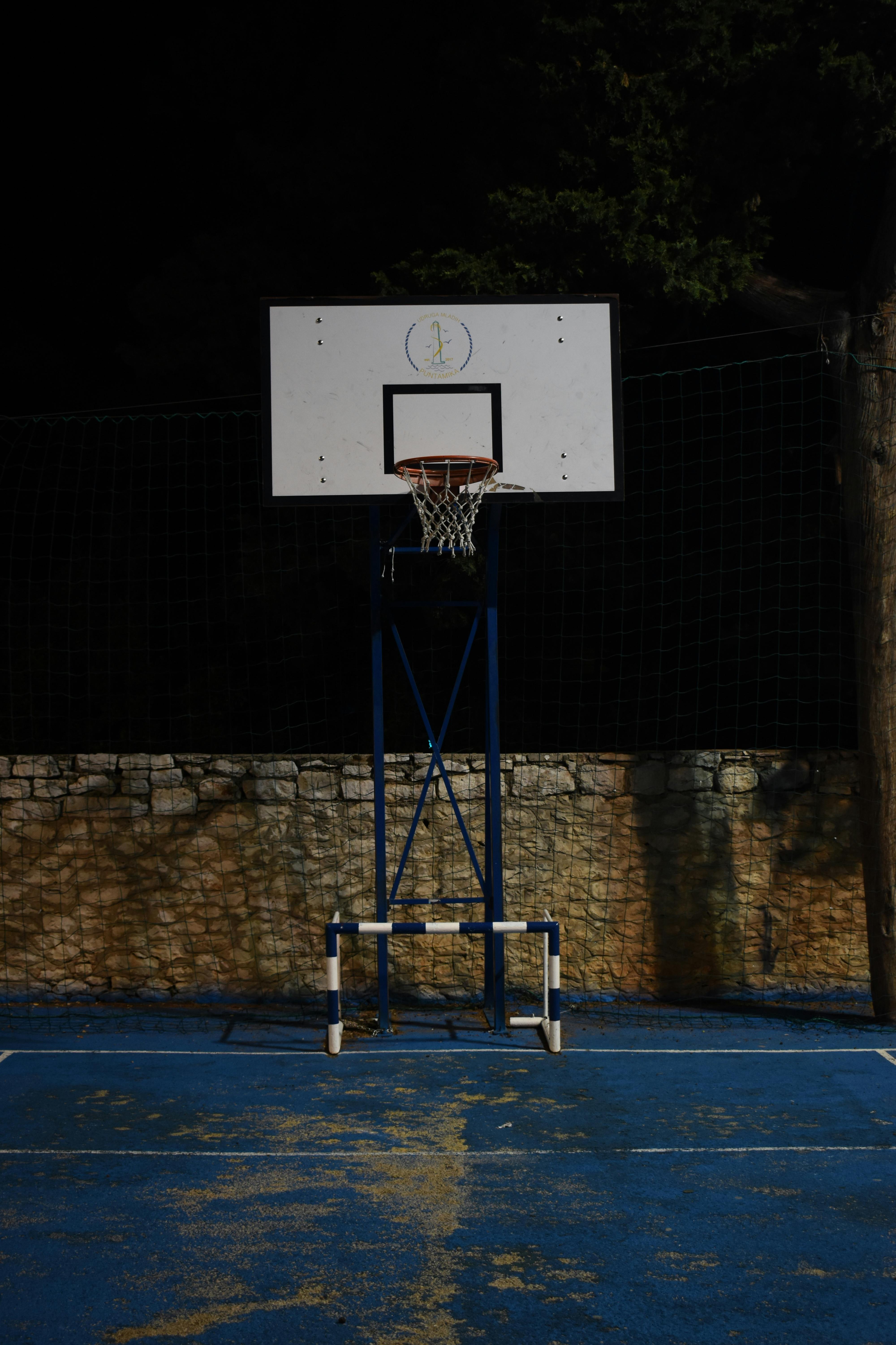 Basketball Hoop Near the Brown Block Wall · Free Stock Photo