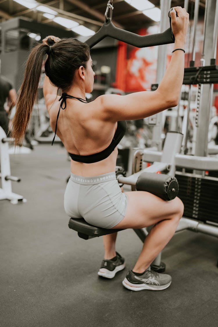 Woman Exercising Back At Gym