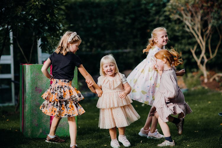 Girls Playing In A Garden