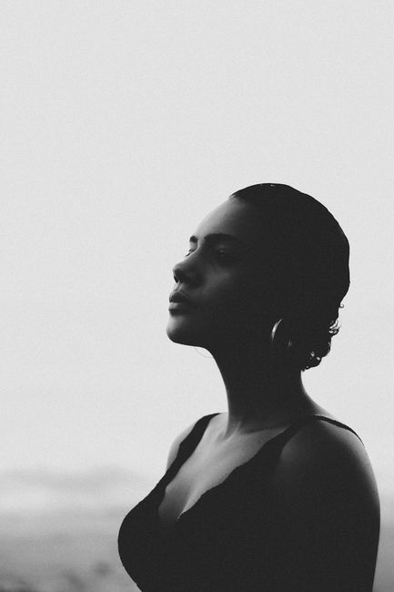 Black and white side profile portrait of a woman in a contemplative pose.