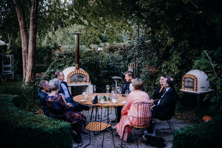 People Sitting Together In Garden