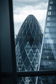 Modern architectural view of the iconic Gherkin building in London, UK.