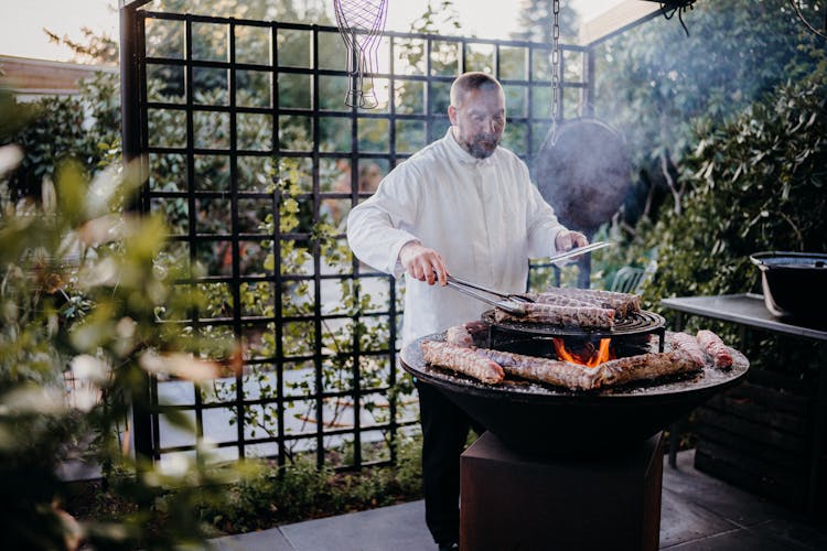 Man Cooking In Garden