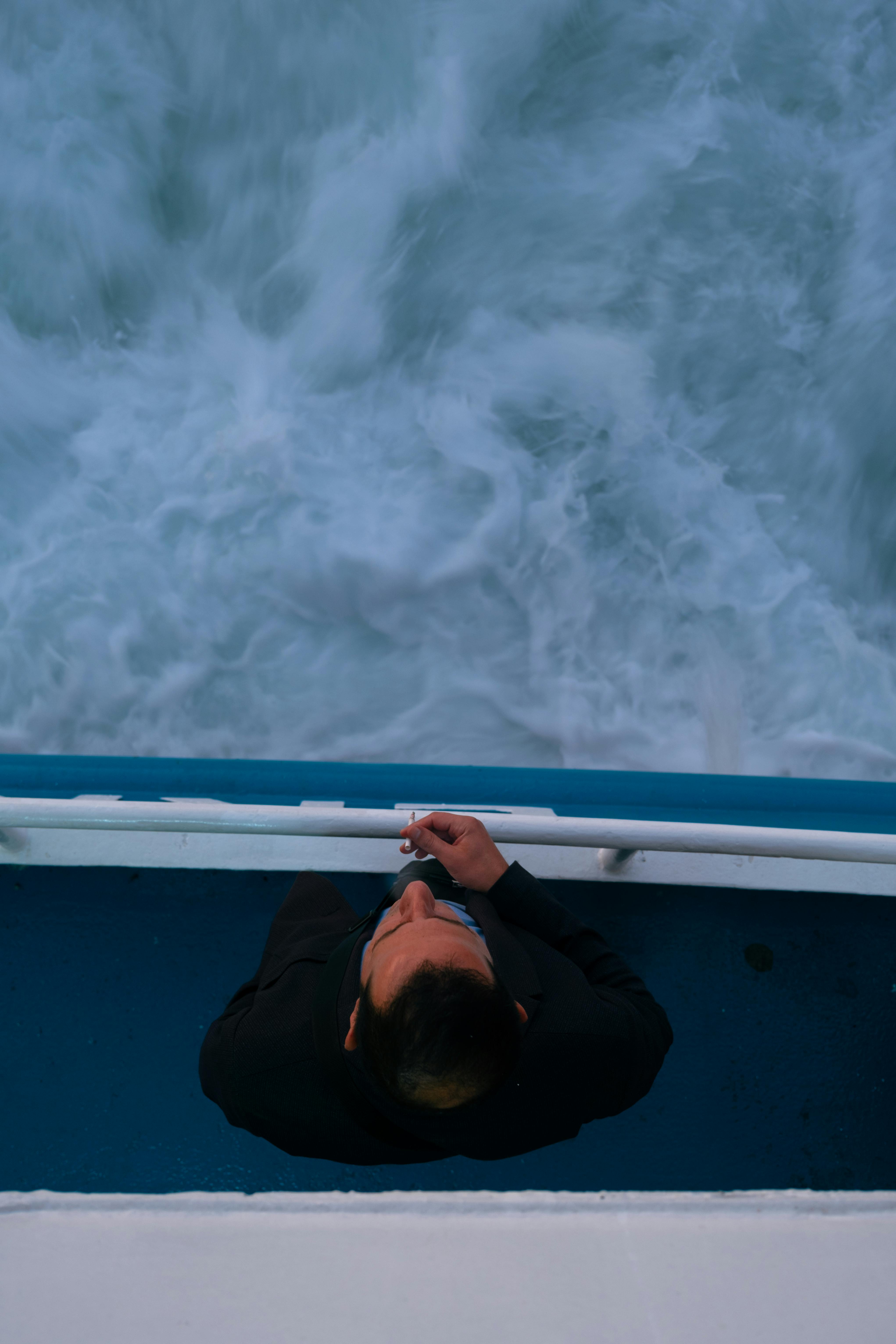 A Man in Black Jacket Riding in a Boat · Free Stock Photo