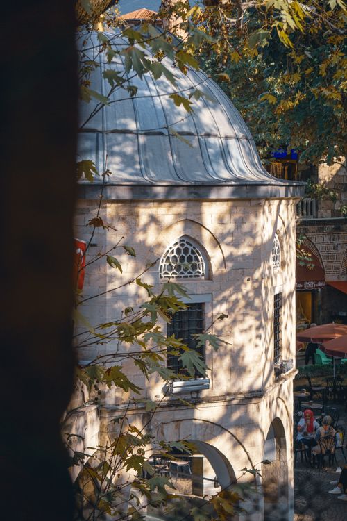 Free Ottoman-style mosque with leaves in Turkey, showcasing traditional architecture. Stock Photo