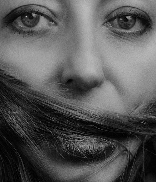 Grayscale Photo of Woman's Face in Close-up Shot 