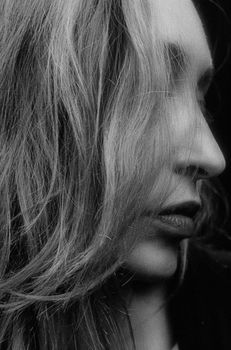 Artistic black and white side view portrait of a woman in Kyiv, Ukraine.