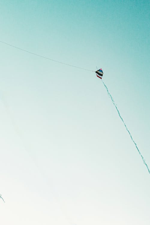 A Colorful Kite Under the Clear Blue Sky