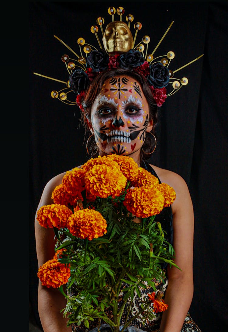 A Woman In Catrina Makeup Wearing A Headdress