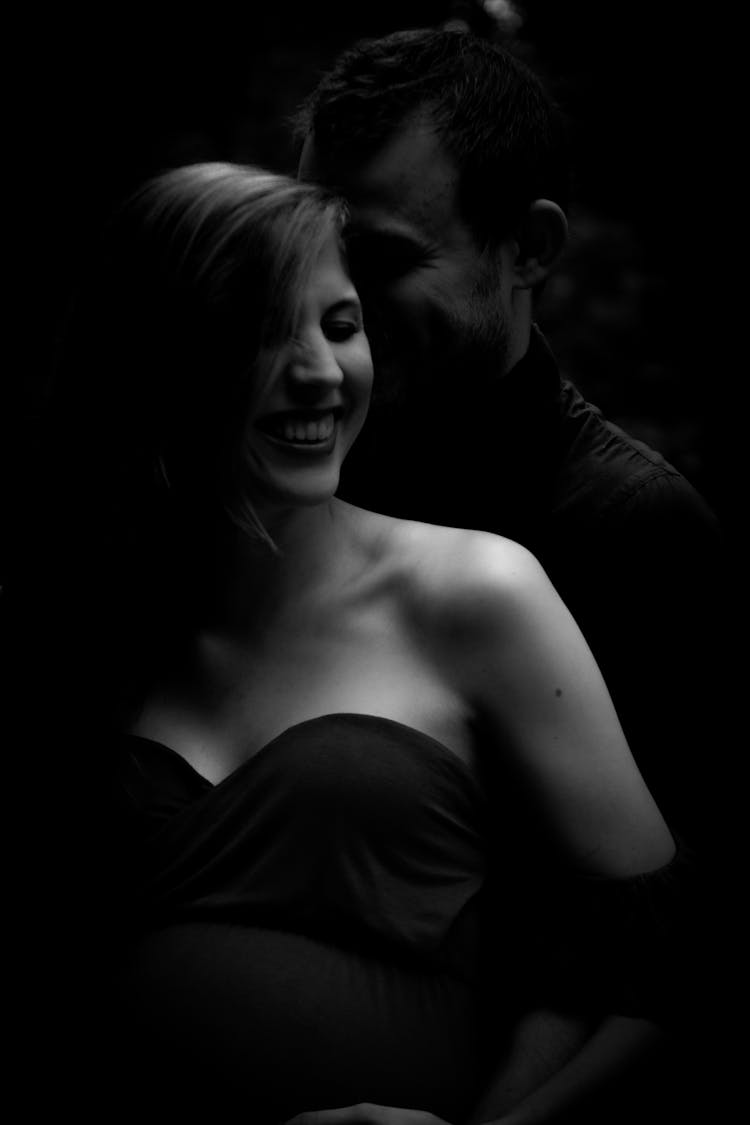 Grayscale Photo Of Couple Laughing While Posing 