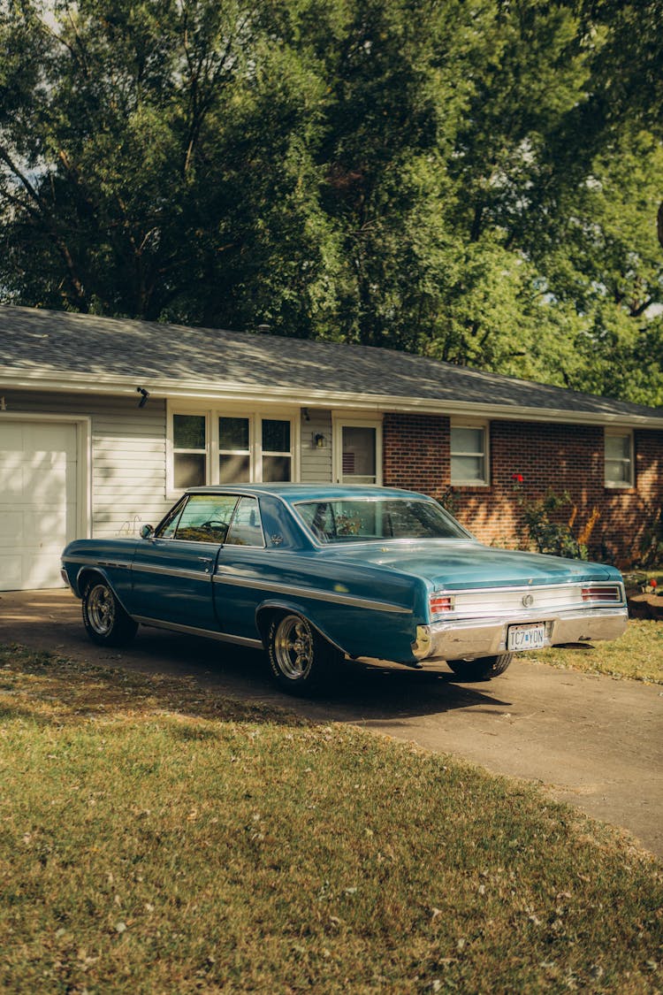 A Vintage Car On A Driveway