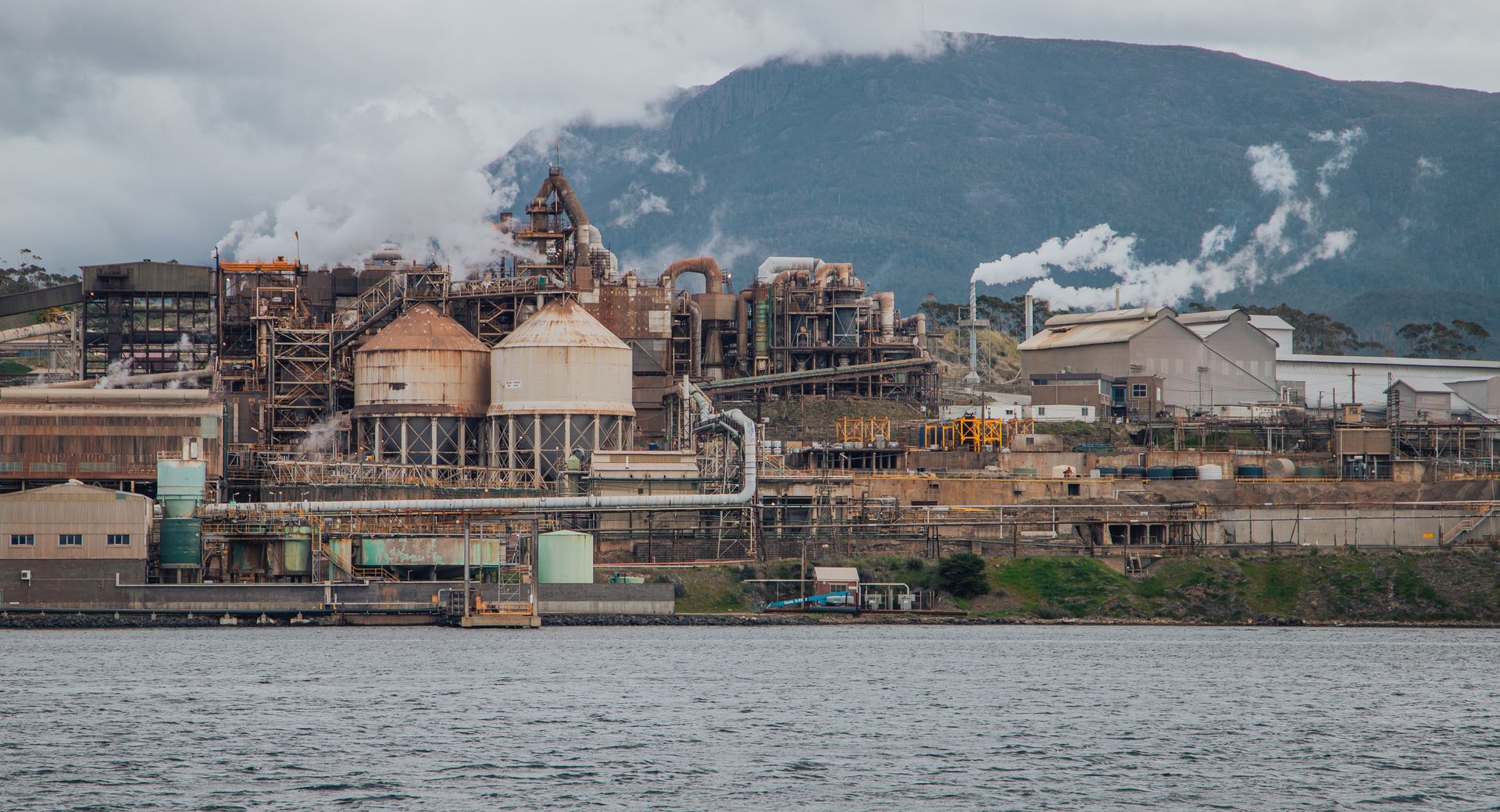 An industrial smelter plant by the coast in daylight