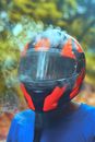 Person Wearing Orange and Black Full-face Helmet