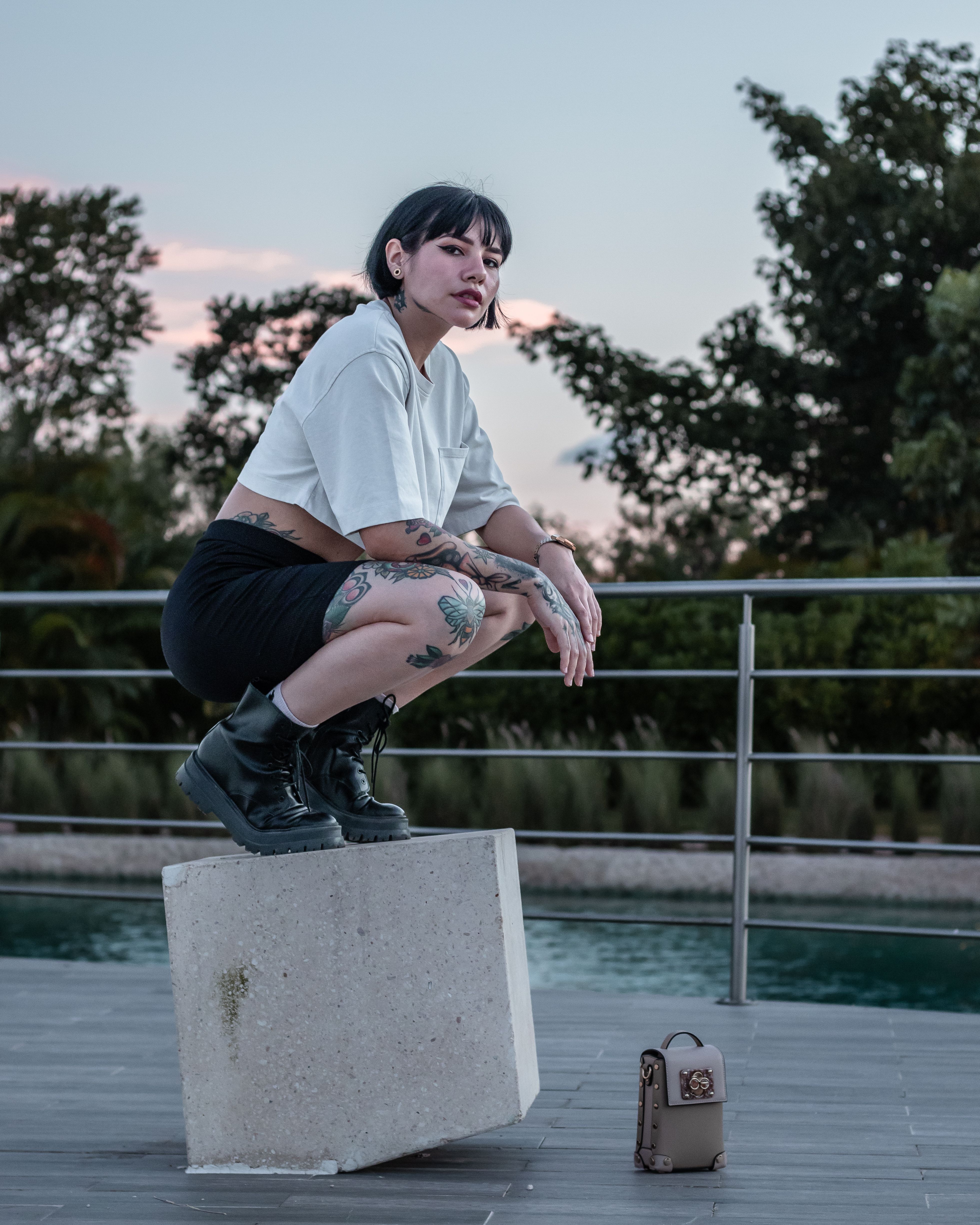 A Woman in a Crop Top and Biker Shorts Crouching on a Block · Free ...