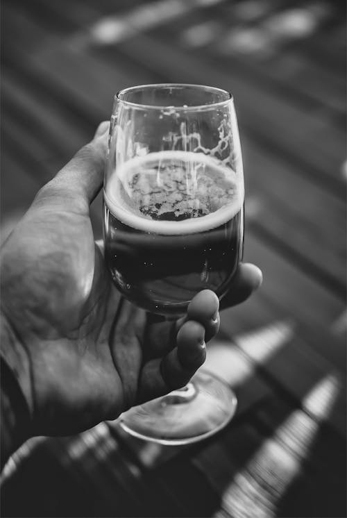 Man Holding a Glass of Beer 