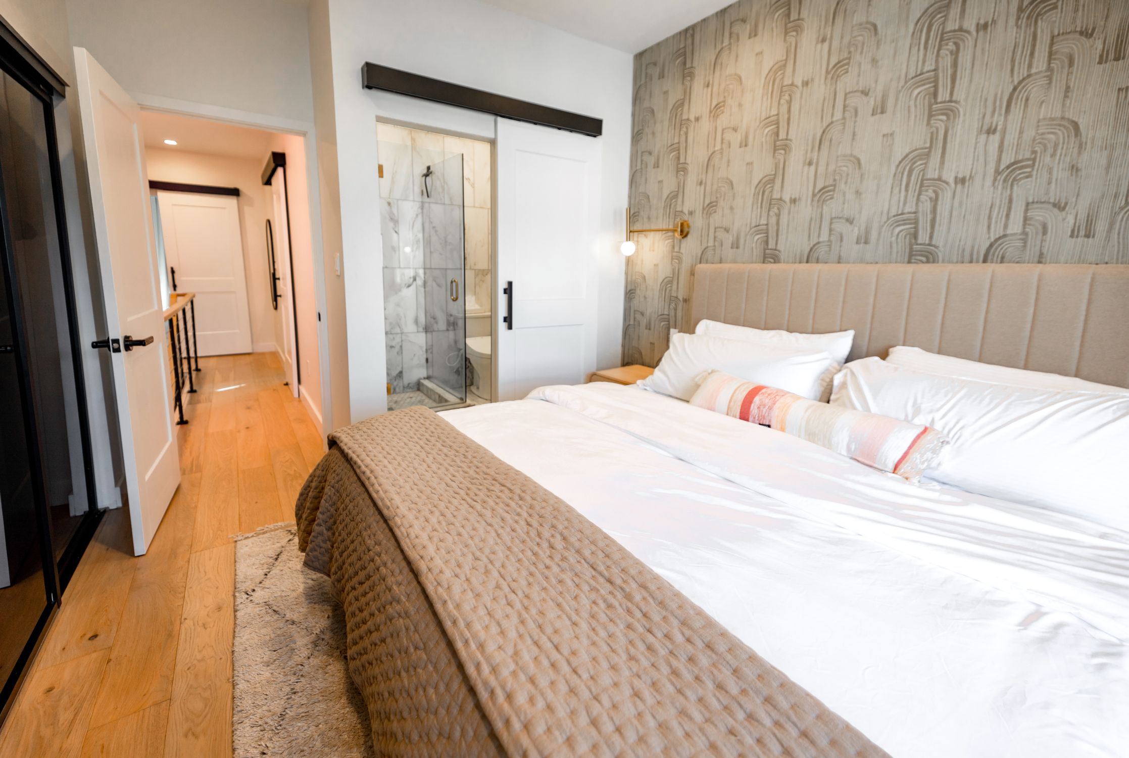 A stylishly designed modern bedroom featuring elegant decor and cozy ambiance.