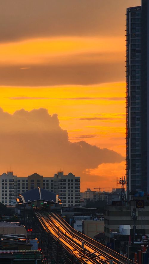 Free Capture of Bangkok cityscape during a vibrant sunset with visible traffic and buildings. Stock Photo