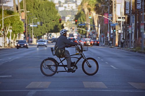 Photograph of a Man Riding a Bike on the Road