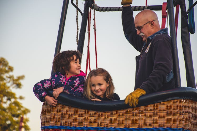 Man And Two Girls Riding On Hot Air Balloon