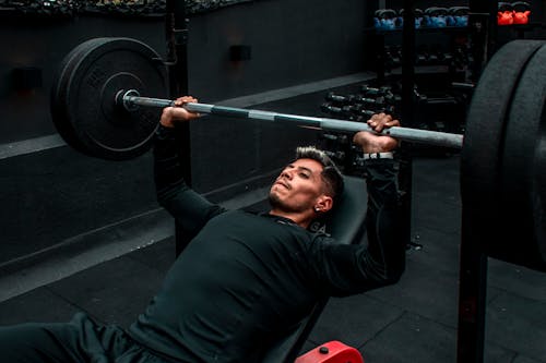 Photo of Man lifting a Barbell