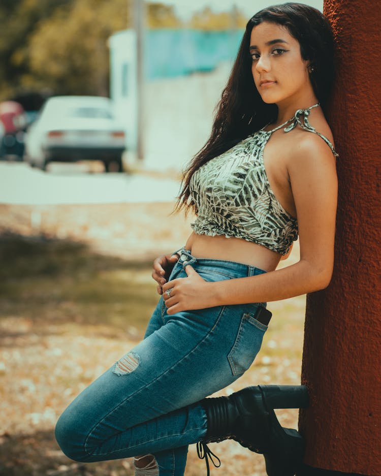 Young Woman Leaning On A Post