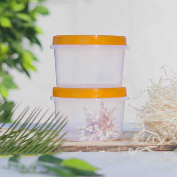 A Plastic Containers With Yellow Lids