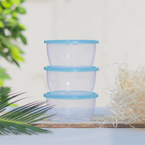 A Stack of Plastic Containers with Blue Lids