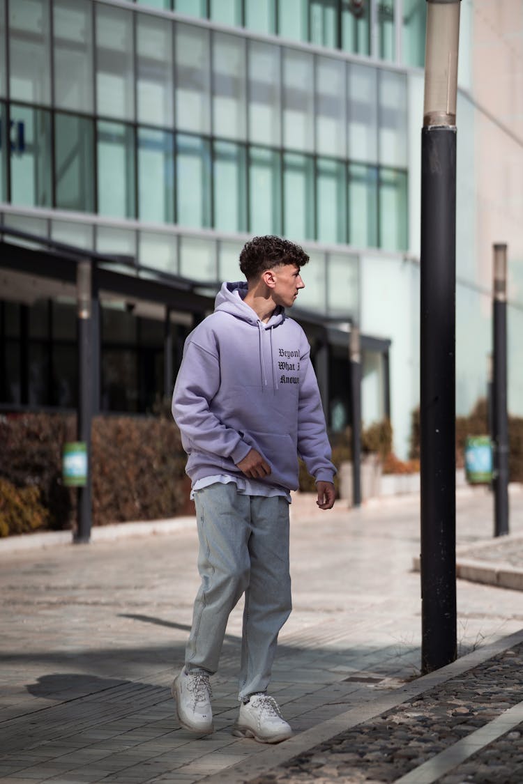 Man In Purple Hoodie Walking On The Street