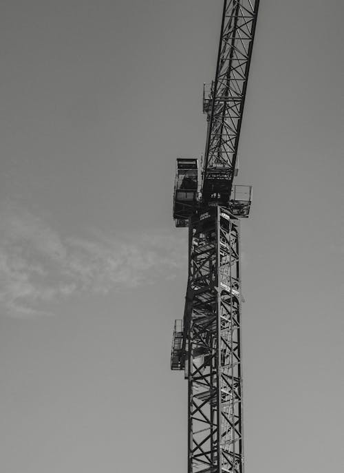Grayscale Photo of a Tower Crane