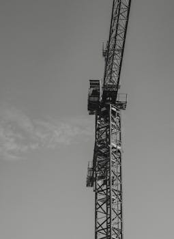 Black and white tower crane in Vancouver, BC, captured with low angle shot conveys construction theme.
